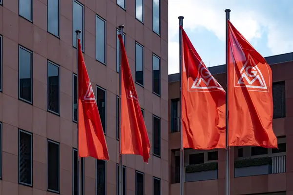 stock image Red IGM flags IG Metall sign, German dominant metalworkers union on building, holding sign in support, Europe's largest industrial union, Frankfurt - July 22, 2024