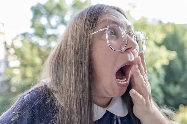 stock image very surprised woman with eyes bulging from shock, bulging eyes, funny face, mental health, mouth open in surprise, moment disbelief and awe