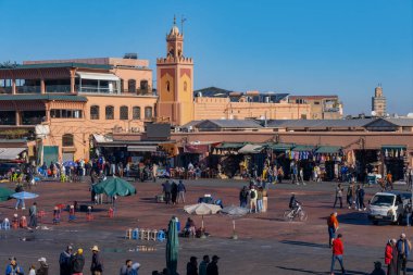 Jamaa el Fna Square in Marrakech, Al-Koutoubia Mosque, tradition and ancient customs Morocco, teeming with life and cultural richness, Marrakech, Morocco - January 7, 2024 clipart