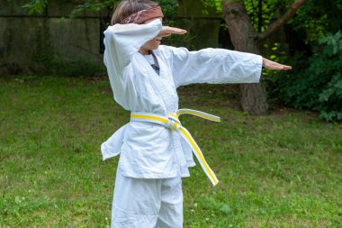 young judoka boy, child in judo uniform, white-yellow belt hone skills, forging resilience through martial arts, martial arts training, physical fitness, athletic skills clipart