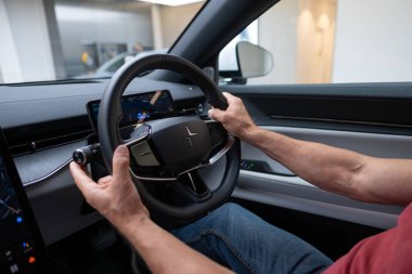 steering wheel Polestar 4, cockpit, left-hand drive interior Volvos EV subsidiary, featuring sleek lines and high-end finishes for sophisticated automotive environment, London - September 17, 2024  clipart