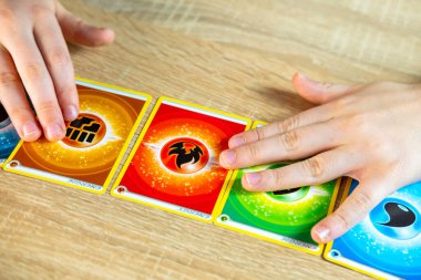 Young hobby enthusiast, child holds colorful collection Pokemon trading card game, trading and collecting, Pokemon Fan Culture, Frankfurt - November, 18, 2024 clipart