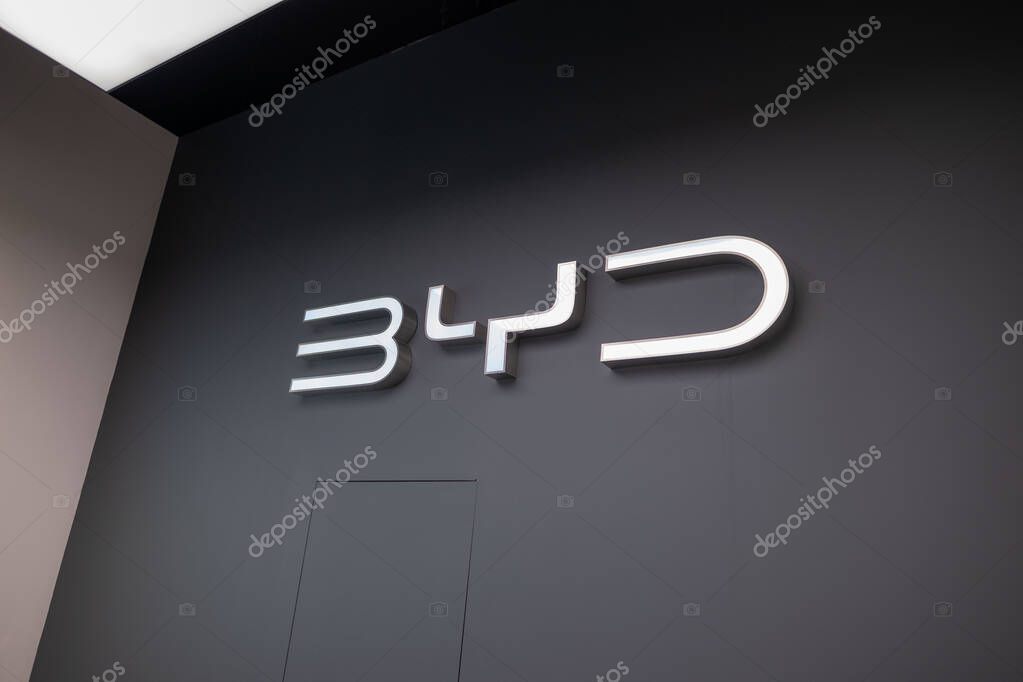 Advertising banners BYD on black background, Chinese conglomerate manufacturer BYD Auto, corporation logo sign, company brand logotype signboard in office, London - September 16, 2024