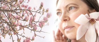 mature pensive woman critically examines appearance, magnolia flowers, wrinkles on skin, Aging, Self-acceptance, contemplating appearance, self-acceptance and journey aging with grace and dignity clipart