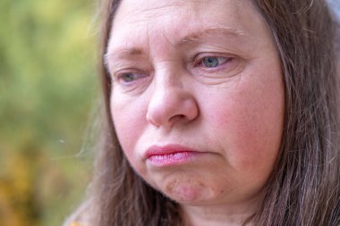 Mature woman in deep sadness, sorrowful expression, dramatic emotional portrait grieving woman, face embodying loss, inner turmoil and despair, broken heart clipart