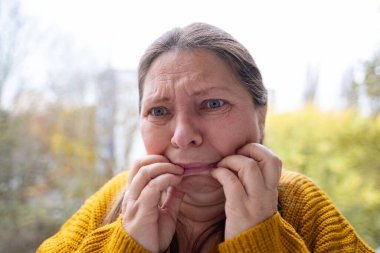 close-up face middle-aged woman, grieving person with tears streaming down face, emotional portrait, deep despair, crying intensely. Emotional pain, grief, and loss