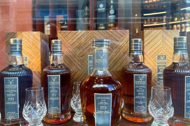 Glenmorangie The Quinta Ruban 14 yaşında, malt viski şişesi içki dükkanında rafta, diğer Glenmorangie ürünleri ile çevrili, sanat ve pop kültürüyle bağlantılı.