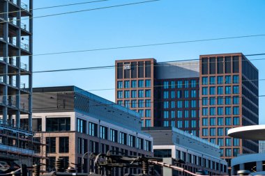 modern building with prominent iconic DB logo against blue sky, corporate Deutsche Bahn building transportation and connectivity against glass facade railway station, Frankfurt - January 19, 2025 clipart