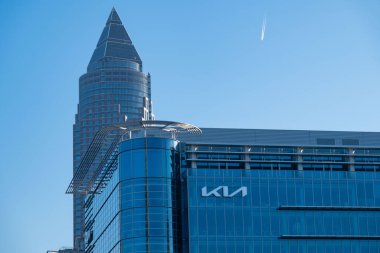 iconic Kia logo stands out against Messeturm Frankfurt, Global Tower skyscraper, innovation and design in automotive industry in Frankfurt am Main, Hesse, Germany, Frankfurt - January, 19, 2025 clipart