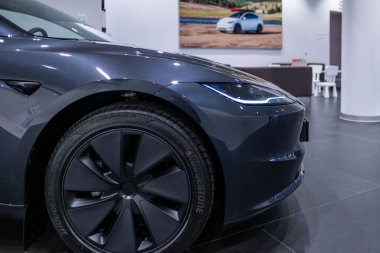 Parlak siyah Tesla Model 3, fütüristik farlar ve ikonik aerodinamik tasarım modern sergi salonunda sergileniyor, elektrik gücü Elon Musk şirketi Frankfurt 'ta - 25 Ocak 2025