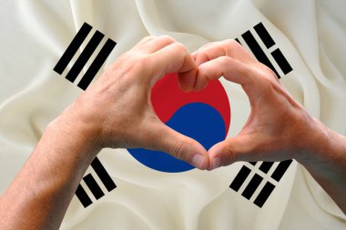 close-up of male hands in heart form against background of silk national flag of South Korea, patriots of country concept, Independence day, travel, international cooperation clipart