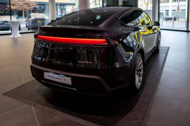 Yeni Tesla araba Model Y Juniper 2025 Studio 'da, galeride siyah metalik elektrikli araç, arka ışık barı, alternatif enerji geliştirme konsepti, Elon Musk şirketi, Frankfurt - 3 Şubat 2025