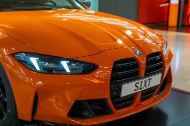 Luxurious orange BMW M4 Competition G82 Coupe, aerodynamic design, modern German sporty performance, automotive engineering and high-performance vehicles in Germany, Frankfurt - February 11, 2025 clipart