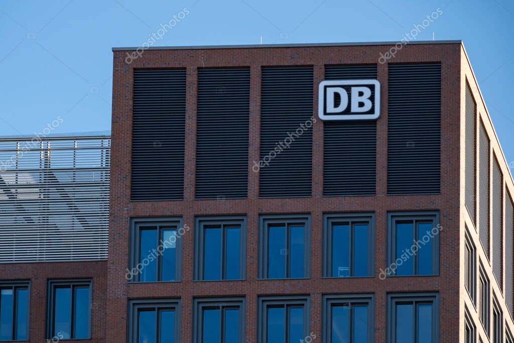 Modern building with prominent iconic DB logo against blue sky, corporate Deutsche Bahn building transportation and connectivity against glass facade, Frankfurt - January 19, 2025