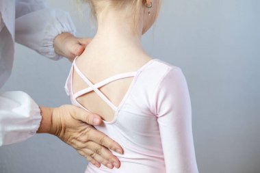 Ortopedist doktor omurga muayenesi yapar çocuk, bale mayosu giyen genç kız omurga eğriliği, omurga deformasyonu, sağlık hizmeti sağlayıcısı, omurga denetleme çocuğu, bale kıyafeti, sağlık kontrolü