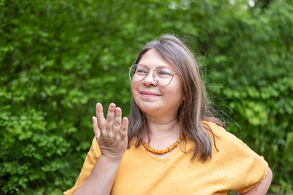 Woman touching hand to collar bones and dcolletage, examines wrinkles on skin, freckles and moles, age-related skin changes, aesthetic injection cosmetology, care anti-aging procedures 