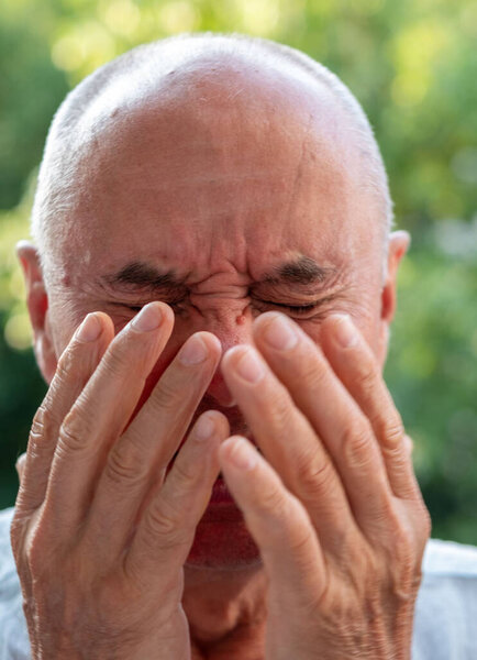 man 60-65 years old, senior crying, suffering, fatigue syndrome eye Asthenopia, eye pain symptoms, including strain, allergies, severe eye conditions, corneal ulcers, glaucoma or acute angle-closure