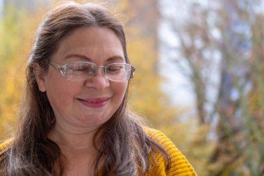 Kuşkucu olgun kadın açık havada, kadın yüzü hayal kırıklığını, şüpheciliği ve duygusal acıyı gösteriyor. Yakın plan, hayal kırıklığını ve şüpheyi gergin bir pozla ifade eden kadın modeli. 