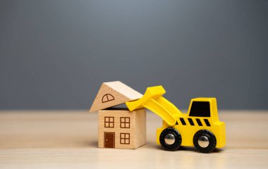 The bulldozer demolishes the house. Encroachment on private property. Illegal buildings and construction. Violation of building codes. Housing renovation. Renovation of an old real estate fund.