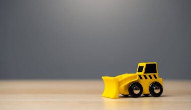The yellow bulldozer toy. Construction works. Clearing and leveling the land. Building destruction. Take down Illegal construction. Industry