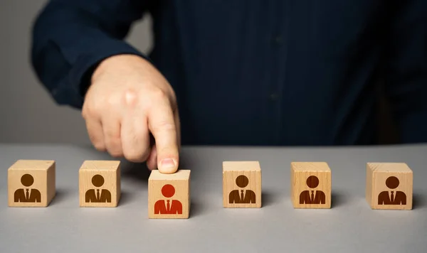 stock image Selected highlighted person from the group. Present an employee with a promotion. Hiring by competition. Get a raise. Select and designate an employee for higher post. Career advancement.