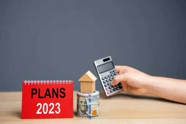 Notes Plans 2023 and houses with money. Real estate planning and financing concept. Housing market. Mortgage, loan, investment. Repairs and refinance home. Forecasts