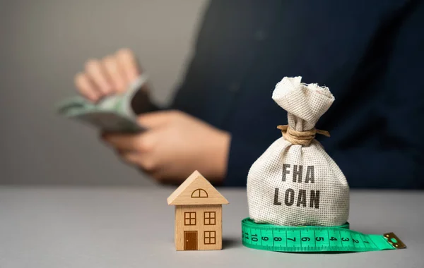FHA loan concept. Mortgage insured by Federal Housing Administration Loan. Affordable loans for borrowers with a low credit score. Down payment. Purchase or refinance a primary residence.