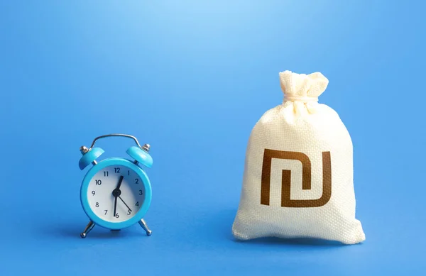 Time and israeli shekel money bag. Loans, mortgages. Deposits, savings. Retirement funds. ROI. Bonds, dividends. Bank, finance. Investments. Hourly pay. Time of payment in the contract. Taxation
