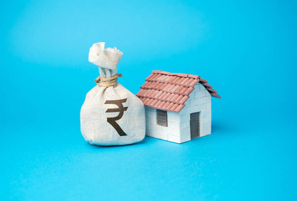 House and indian rupee money bag. Buy a house. Real estate investment. Property value appraisal. Make a deal. Property Insurance. Taxes.