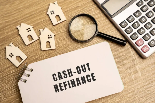 Cash-out refinance concept. Allows a homeowner to use the equity in their home to get funds. Real estate, credit and mortgage concept. Wooden houses, notes and magnifying glass
