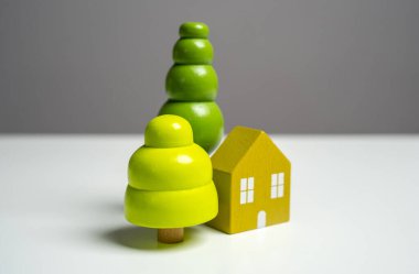 Bir ev ve ağaç figürleri. Binanın tasarımı, inşaatı ve yeniden inşası. Bir rüya evi yarat. İpotekle al. Bahçe işleri, manzara tasarımı..