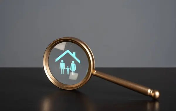 Magnifying glass and family under the roof. The concept of finding housing for young families. Focused search for the ideal dwelling. Housing solution