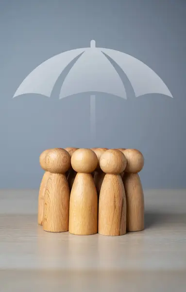 A group of people and an umbrella above. The concept of insurance and social protection. Life insurance. Customer care. Human resources.