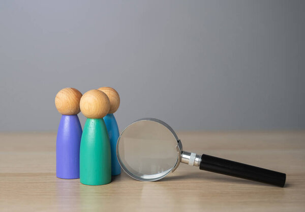 Group of people and magnifying glass, figures. Recruiting, staffing. Hiring best talented professional candidate for a vacant job position. Employment agency. Human resources. Headhunter.