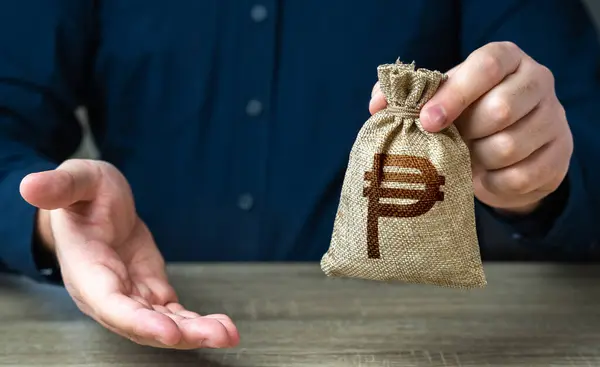 Giving gesture and philippine peso money bag. Banking and crediting. The man offers a deal in return. Salary benefits. Attracting investments. Mortgage, loan approval. Deposit savings. Cashback.