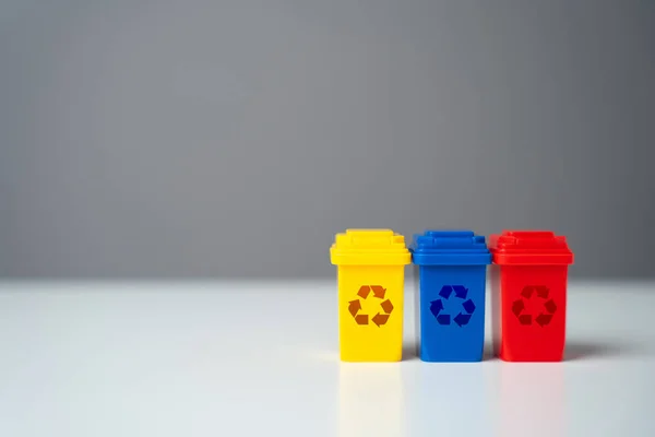 Colored waste recycling bins. Conserve natural resources, reduce waste, create jobs in recycling industry. Selling recycled material or getting grants for green projects. Circular economy.
