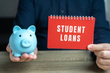 Student loans concept. Financial aid provided to students to help cover the cost of higher education. Note in male hands and pig piggy bank clipart