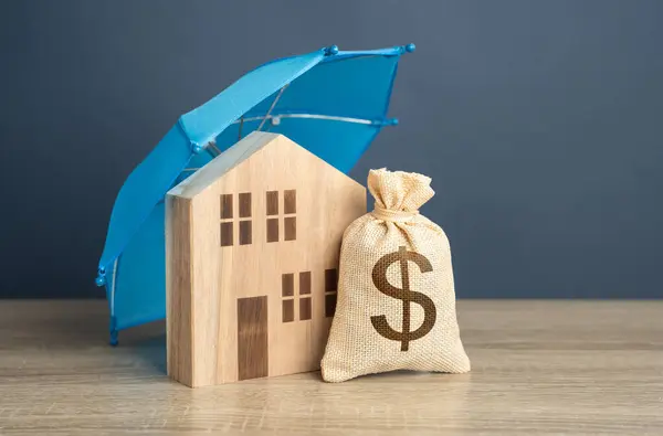 House with dollar money bag and blue umbrella. Financial security. Protect investment and be prepared for unforeseen events. Repairs or rebuilding in the event of a covered loss. Property insurance.