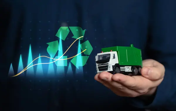 stock image Waste recycling and business. Investing in recycled materials. Environmental projects. A businessman holds a garbage truck in his hand. Conserve natural resources, reduce waste. Generate profit.