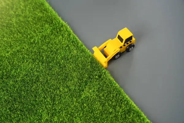 stock image A bulldozer levels the area for construction, concept. Nature destruction of for technogenic development. Urbanization, increasing influence on environment.