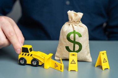 Man removes capital restrictions. Concept, bulldozer demolishes restriction signs around dollar money bag. Lifting sanctions and unfreezing assets. clipart