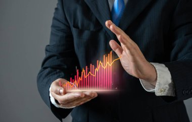 İşadamı kırmızı grafiğin büyümesini durdurmaya çalışıyor. Yüksek giderlerin, suç ve yolsuzluğun artışının göstergesi, diğer olumsuz haberler. Artan harcamalar, ekonomik kriz, maddi kayıplar, enflasyon