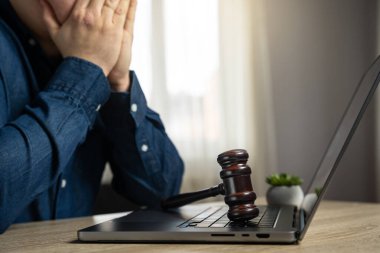 Frustrated man and court gavel on laptop. Laws and regulations. Restrictions and blocking of resources. Restrictions on access to the Internet. Internet earnings, regulation. Censorship clipart