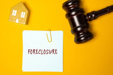 Foreclosure property concept. Legal process in which the ownership shifts to the bank or lender if the homeowner fails to pay the loan. Notes, house and judge's gavel clipart