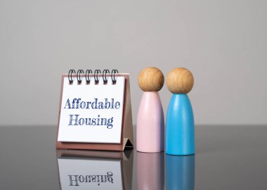 Affordable housing and human figures. Social equity, community support, or simplified homeownership. Support programs for young families and couples. Cheap loans.
