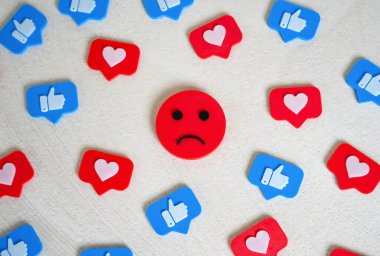 Sad face among social media likes. Burnout and doomscrolling. Chasing likes, social media addiction. Mental health challenges, emotional fatigue, and the dark side of digital life. Dopamine loops