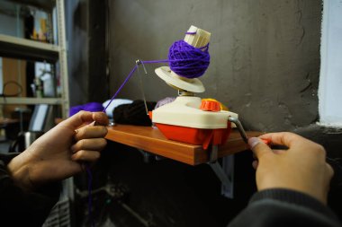 Zanaatkar kadın top camında yuvarlanan ipliğin bir parçası 