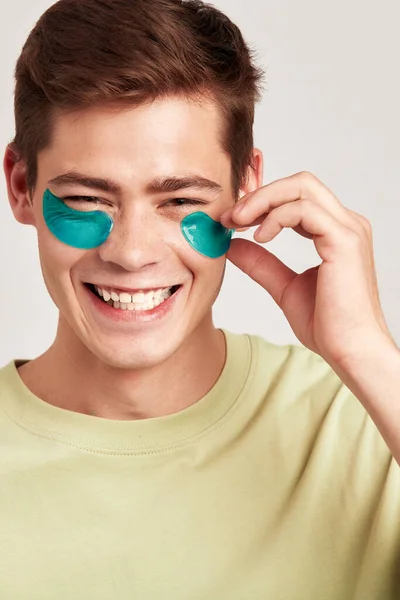 Millennial Guy Brown Hair Practicing Skincare Eye Hydrogel Patches Studio — Stock Photo, Image