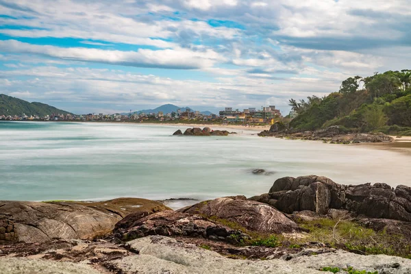 Trees, rocks and waves in Atalaia beach, Bombinhas, Santa Catarina, Brazil