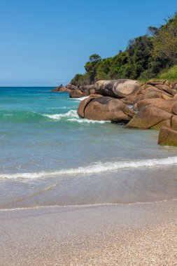 Waves, rocks and vegetation at Barra da Lagoa beach, Santa Catarina, Brazil